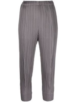 Pleats Please Issey Miyake plissé cropped tapered-leg trousers - Grey