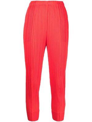 Pleats Please Issey Miyake plissé cropped tapered-leg trousers - Pink