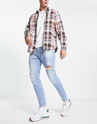 Pull & Bear carrot fit jeans with rips in blue