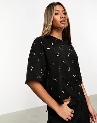 Puma Classics all over logo print t-shirt in black and gold