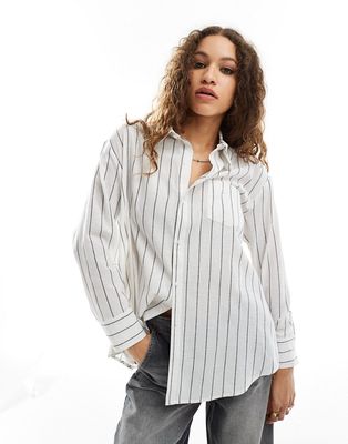 Reclaimed Vintage multi-way asymmetric wrap shirt in black and white pinstripe