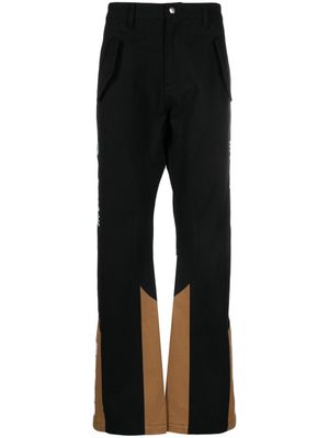 Rhude logo-embroidered panelled trousers - Black