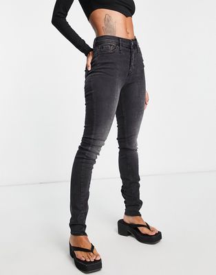 River Island high rise skinny jeans with split zip hem in washed black