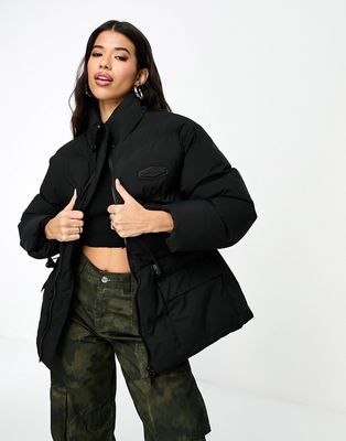 The Couture Club oversized pleated puffer jacket in black with tie waist detail