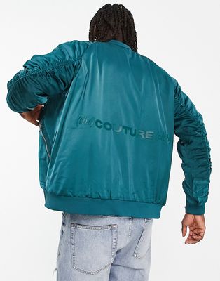 The Couture Club satin bomber jacket in teal blue with ruched sleeve detail
