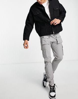 The Couture Club technical cargo pants in gray with snap hem detail