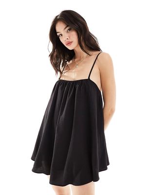 The Frolic Sunstorm easy throw-on volume strappy mini beach dress in black