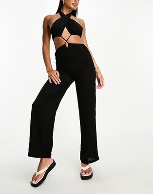 The Frolic tanzanite cut out tie detail halter neck jumpsuit in black