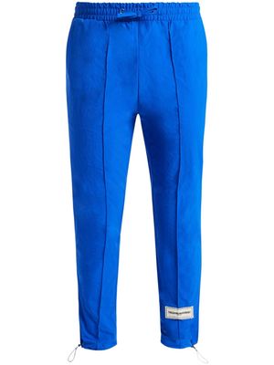THE GIVING MOVEMENT logo-appliqué tapered track pants - Blue