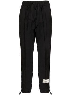 THE GIVING MOVEMENT Skinny Re-Shell100© track pants - Black