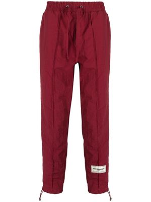 THE GIVING MOVEMENT Skinny Re-Shell100© track pants - Red