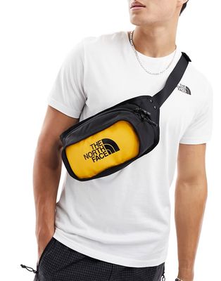 The North Face logo hip pack bag in black and yellow