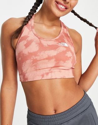 The North Face Training Midline logo medium support sports bra in pink tie dye