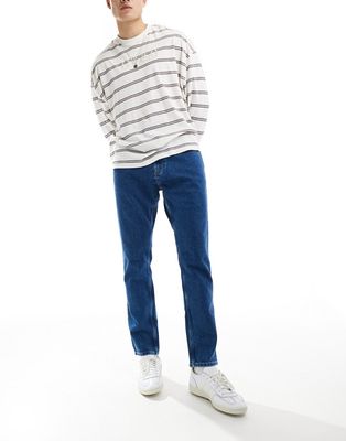 Tommy Jeans austin slim tapered jeans in mid wash blue