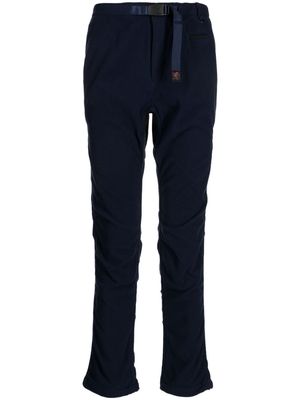 Undercover logo-tag buckle-fastening tapered trousers - Blue