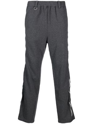 Undercoverism logo-print zipped trousers - Grey