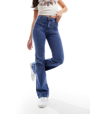 Wrangler super high rise flare with front pockets in mid blue